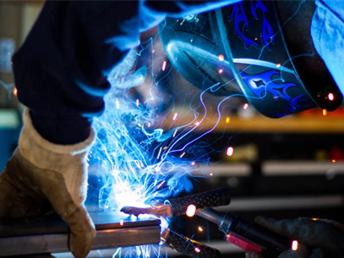 Welder at work with sparks